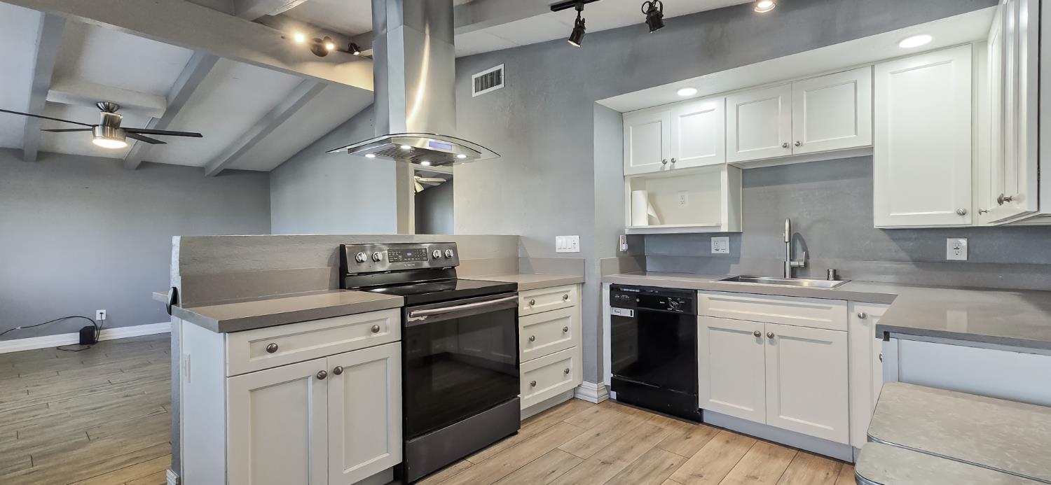 206 West 20th Street Tracy, CA 95376 - Photo 7 of 20 a kitchen with stainless steel appliances granite countertop a stove sink and cabinets