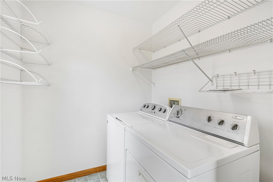 2758 Shellhart Road Norton, OH 44203 - Photo 13 of 41 First floor laundry with washer, dryer and shelving