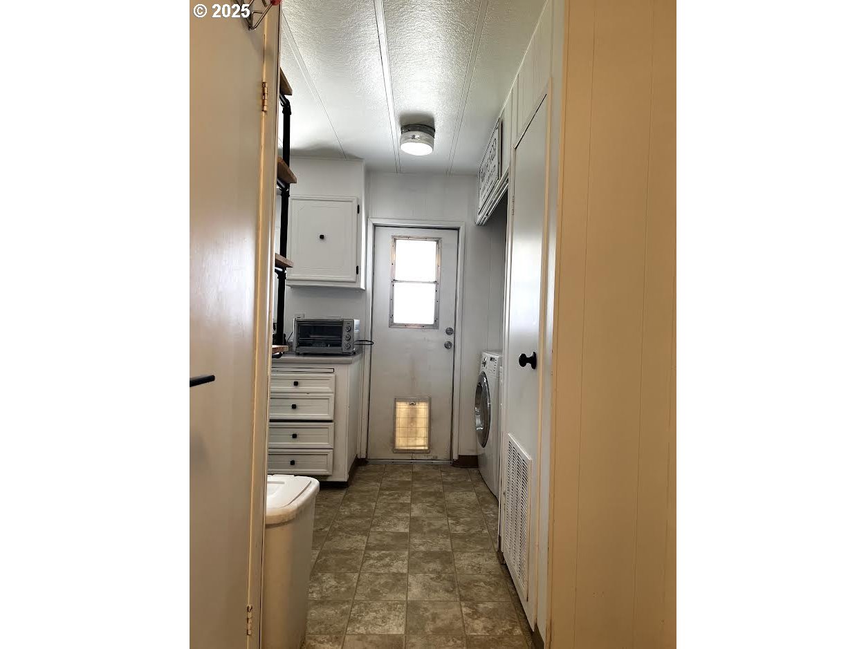 1255 Southwest Sandy Drive Hermiston, OR 97838 - Photo 14 of 16 a view of a hallway with storage and utility
