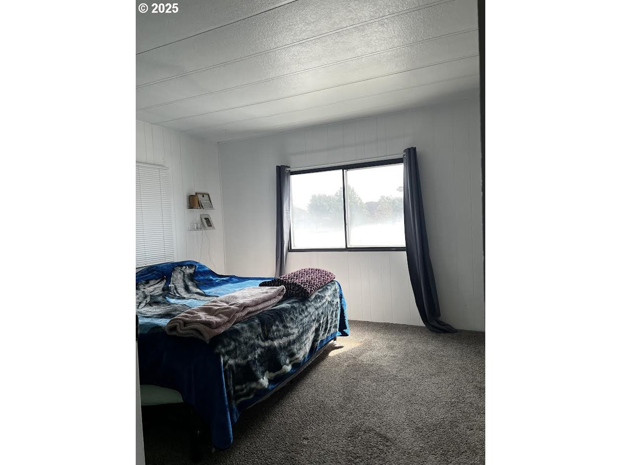 1255 Southwest Sandy Drive Hermiston, OR 97838 - Photo 7 of 16 a bed sitting in a bedroom next to a window