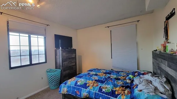 a bedroom with a bed and a dresser in it