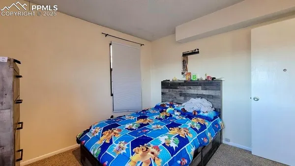 a bedroom with a bed and a dresser