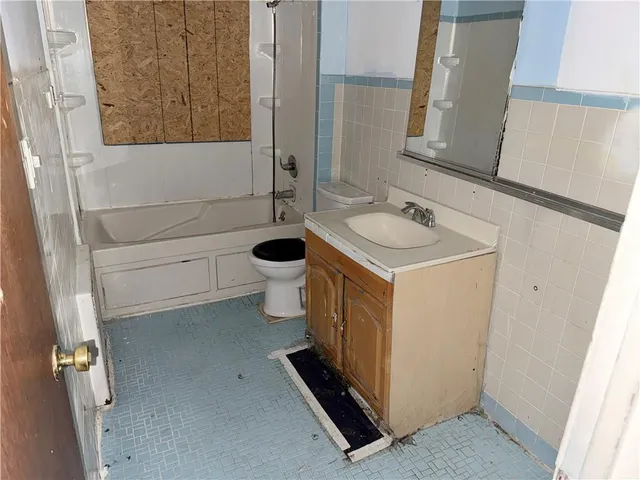 a view of walk in closet with clothes