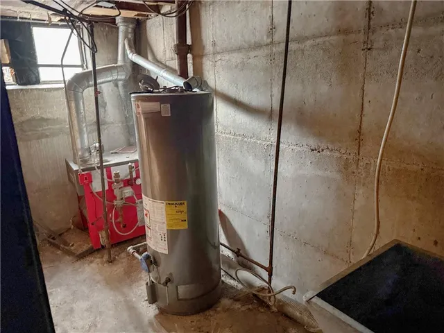 a view of a water fountain under a large tree