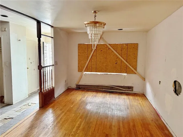 a view of an entryway with wooden floor
