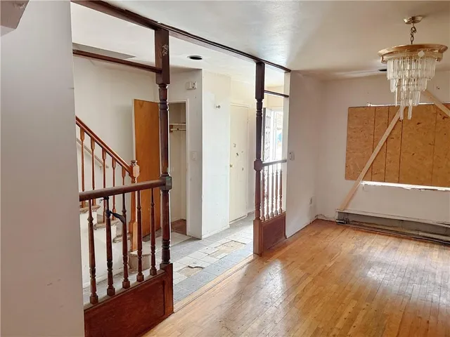 a view of a hallway with wooden floor and entryway
