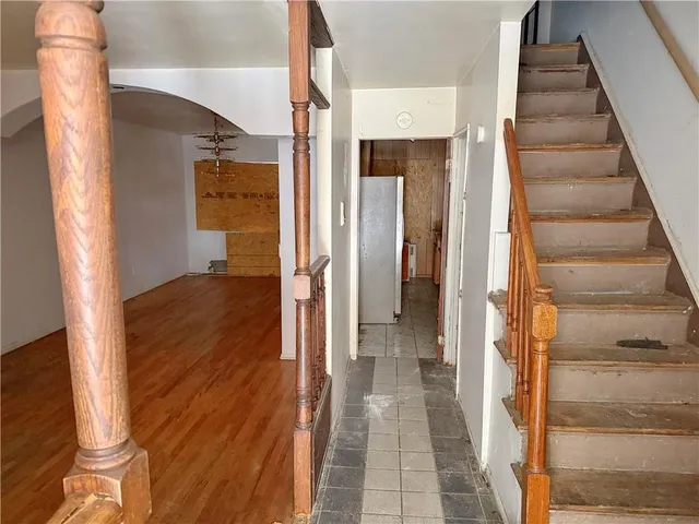 a view of a room with wooden floor and ceiling fan