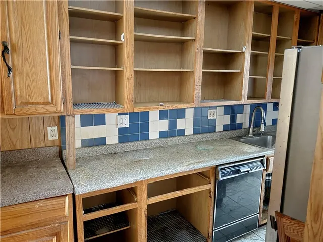 a kitchen with stainless steel appliances a refrigerator and a stove