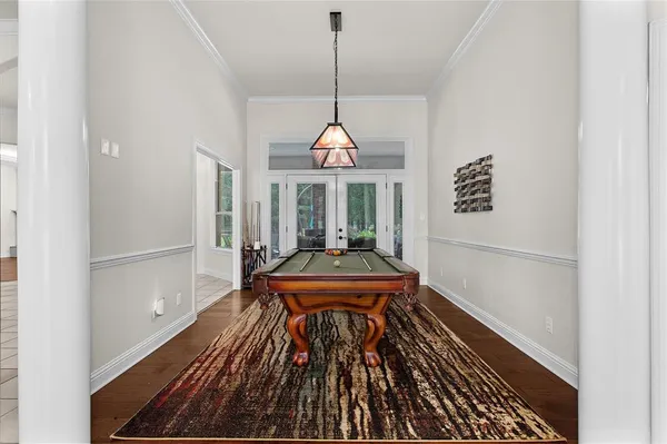 a living room with furniture a table and kitchen view