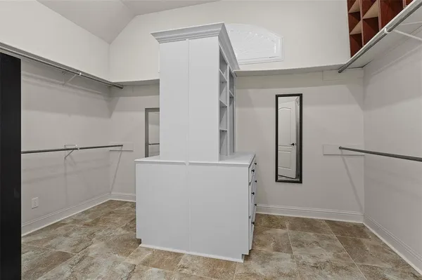 a view of an empty room with window and a flat screen tv