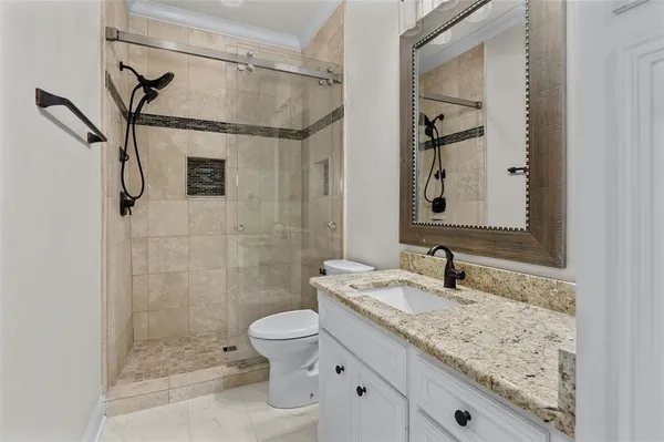 a bathroom with a sink a toilet and shower