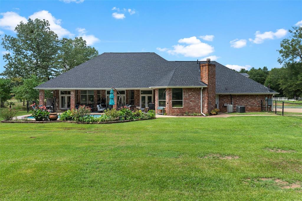 2584 Butler Hill Road Benton, LA 71006 - Photo 31 of 33 a front view of a house with a garden and porch