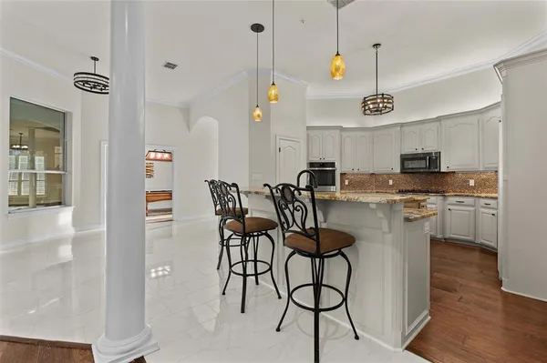 a dinning room and kitchen with a decorative lights