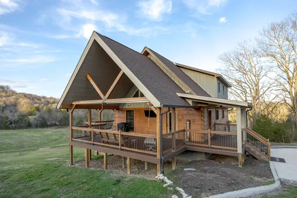 a green field with lots of tall trees