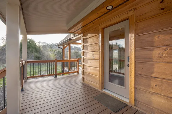 a kitchen with stainless steel appliances granite countertop a stove a refrigerator a kitchen island a dining table and chairs with wooden floor