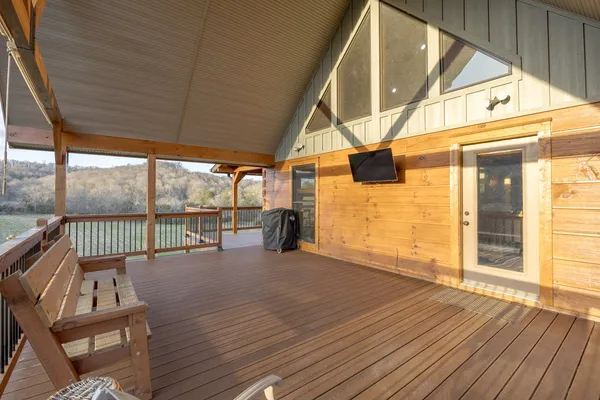 a spacious bedroom with a bed and wooden floor