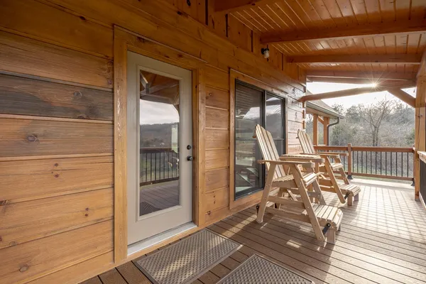 a view of a livingroom with wooden floor and a bathroom