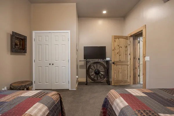 a view of a dry yard with trees in the background