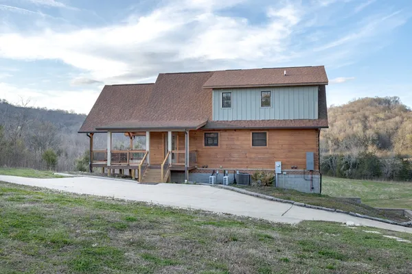 a view of a balcony with chairs and wooden floor