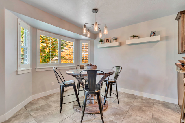 1071 Jamie-Matt Circle Layton, UT 84041 - Photo 22 of 28 Dining area with hanging lights and light tile patterned flooring