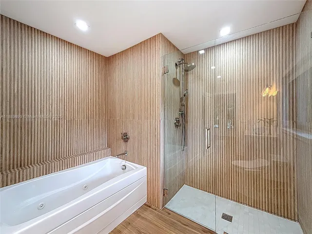 a bathroom with a bathtub and a shower