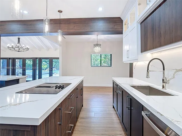 a kitchen with stainless steel appliances granite countertop a sink stove and cabinets