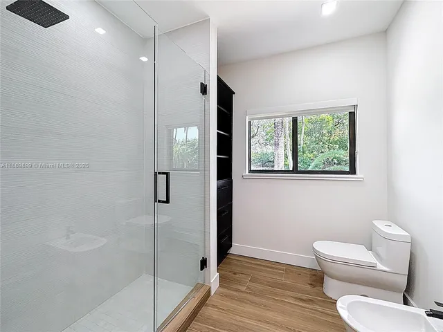 a bathroom with a toilet and a shower