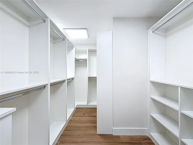 a view of walk in closet with empty racks
