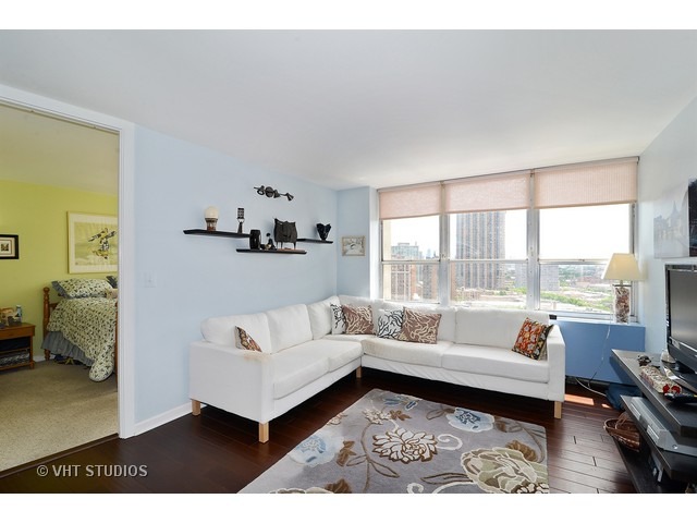 655 West Irving Park Road, Unit 1707 Chicago, IL 60613 - Photo 3 of 14 a living room with furniture and a large window