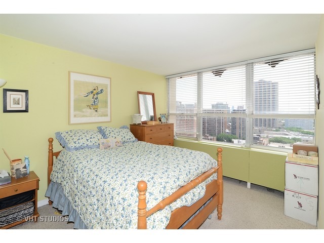 655 West Irving Park Road, Unit 1707 Chicago, IL 60613 - Photo 7 of 14 a living room with kitchen island furniture and a table