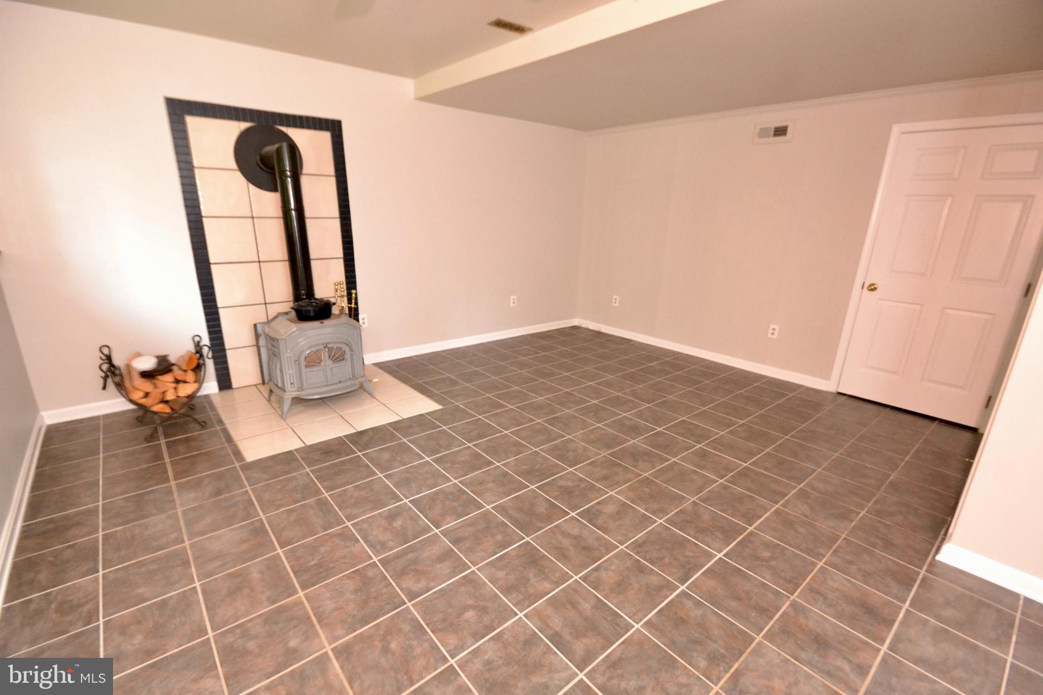 416 Lees Mill Road Hampstead, MD 21074 - Photo 29 of 37 Family Room Lower Level w/ Wood Stove