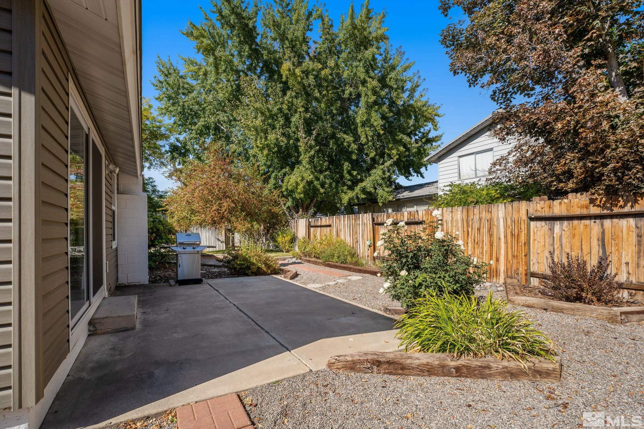 4315 Mendocino Lane Reno, NV 89502 - Photo 27 of 31 a view of a backyard with potted plants and large tree