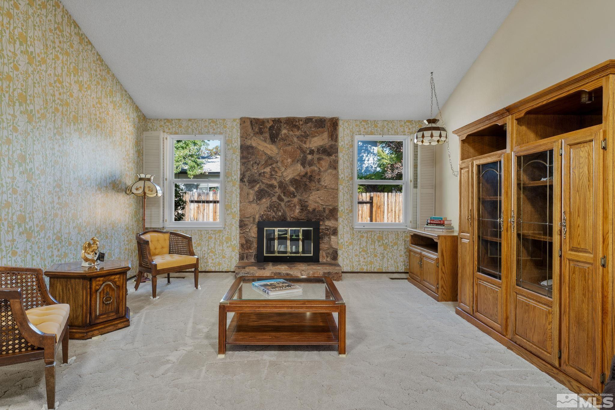 4315 Mendocino Lane Reno, NV 89502 - Photo 7 of 31 a living room with furniture a fireplace and a table