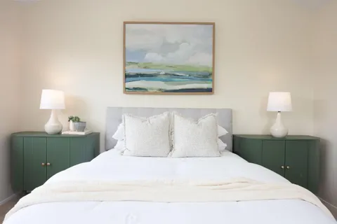 a bedroom with a bed and a large window