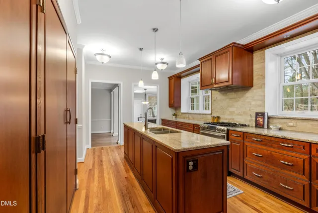 a kitchen with a stove a refrigerator and a sink