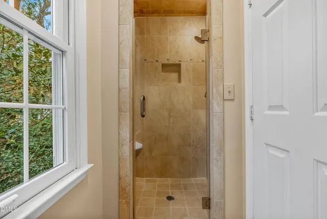 a spacious bathroom with a double vanity sink and a mirror