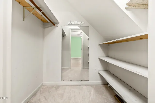 a view of an empty room with a fan