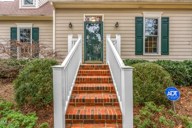a pathway of a house with a yard
