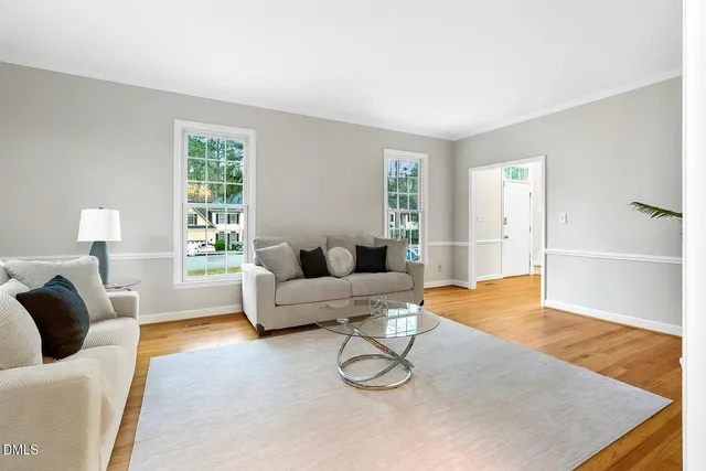 a living room with furniture and a wooden floor