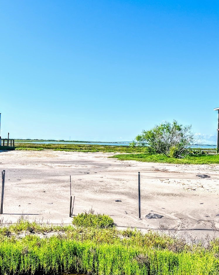 74 Newcomb Bend Loop Rockport, TX 78382 - Photo 2 of 31 a view of a lake with a big yard