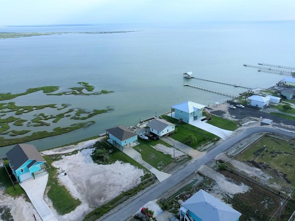 74 Newcomb Bend Loop Rockport, TX 78382 - Photo 8 of 31 an aerial view of a house with a yard