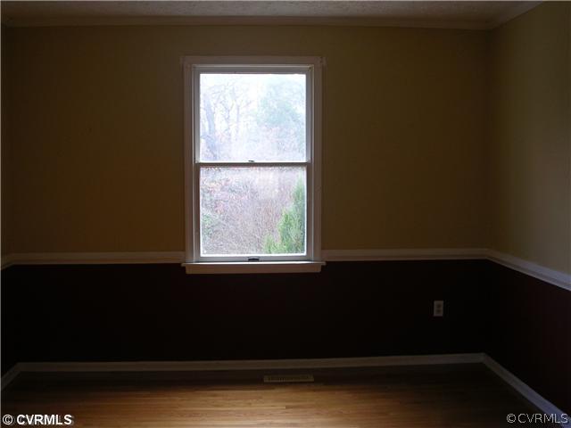 108 Tudor Road Colonial Heights, VA 23834 - Photo 3 of 12 a view of an empty room with wooden floor and a window