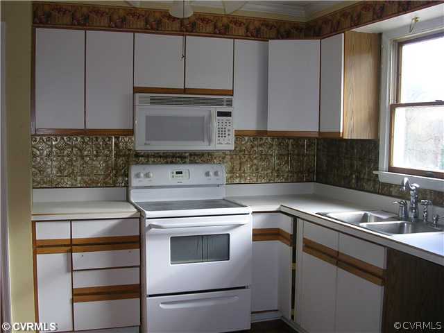 108 Tudor Road Colonial Heights, VA 23834 - Photo 4 of 12 a kitchen with cabinets appliances a sink and a window