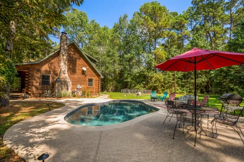 a backyard of a house with table and chairs