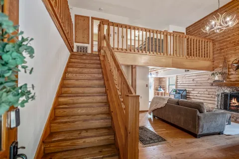 a view of entryway and hall with wooden floor