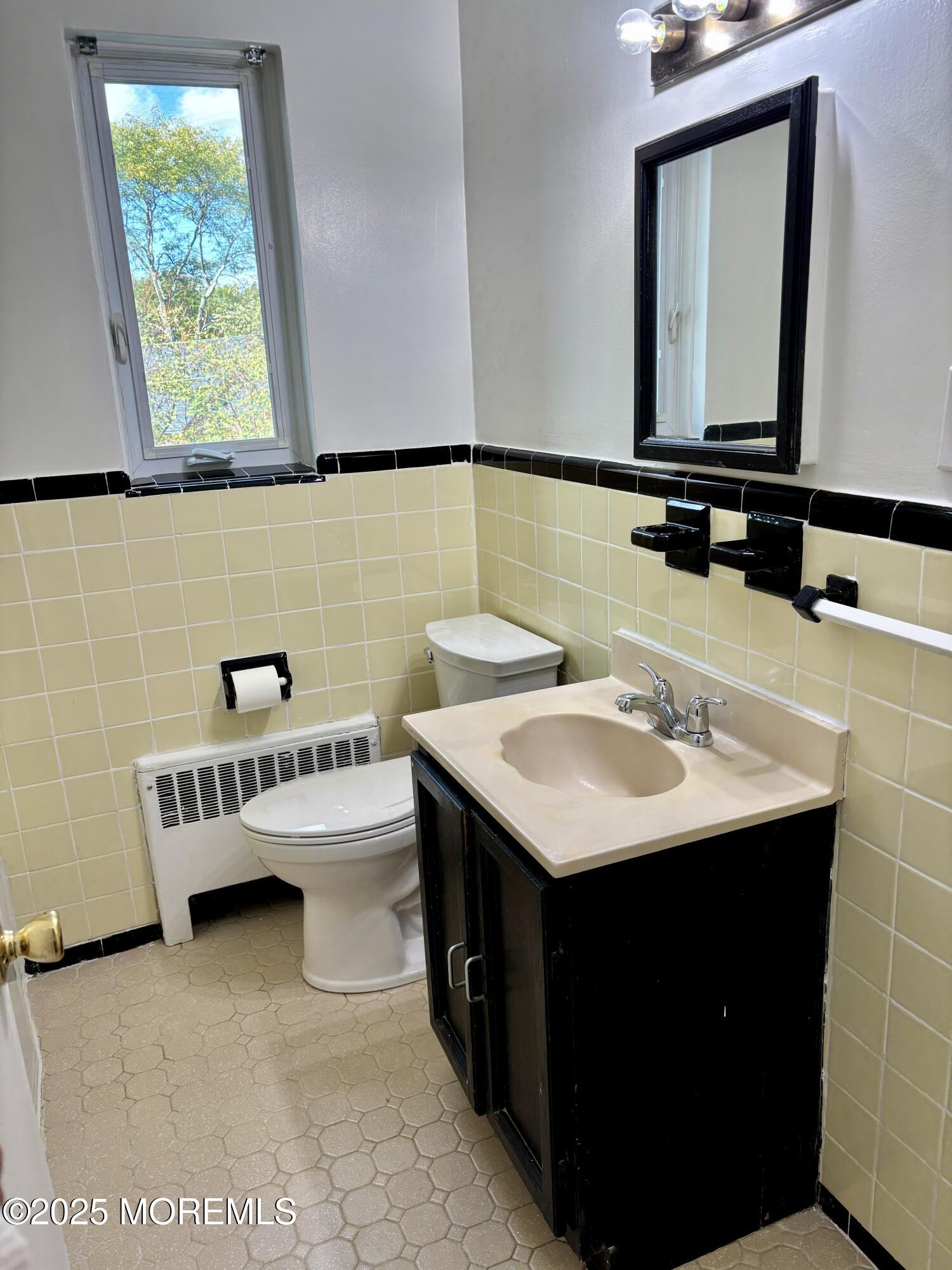 283 Spring Street, Unit 4C Red Bank, NJ 07701 - Photo 16 of 29 a bathroom with a sink and a mirror