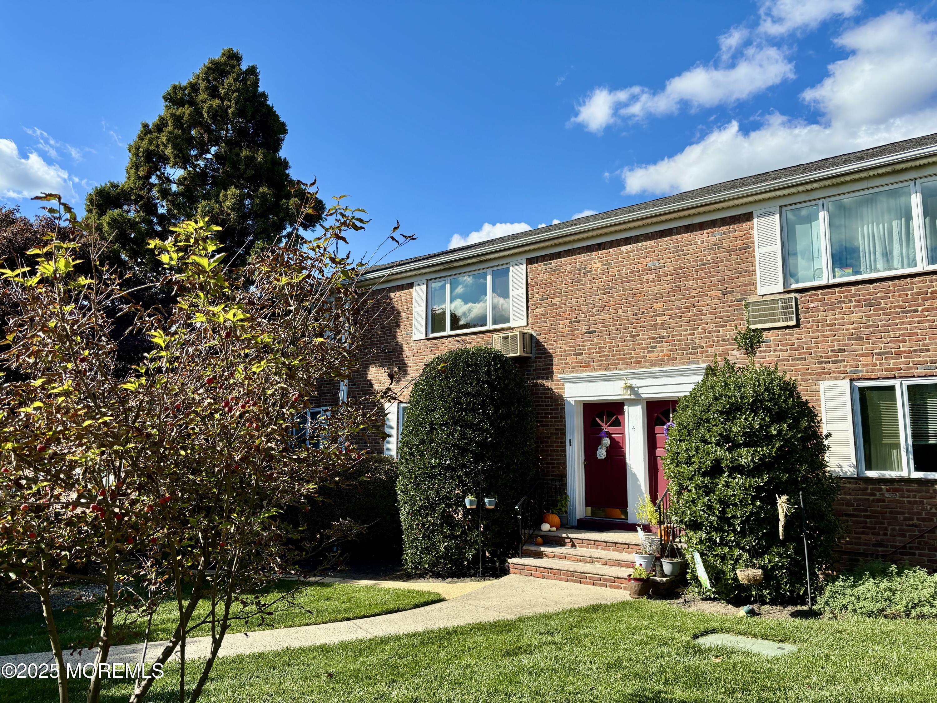 283 Spring Street, Unit 4C Red Bank, NJ 07701 - Photo 25 of 29 a front view of a house with a yard