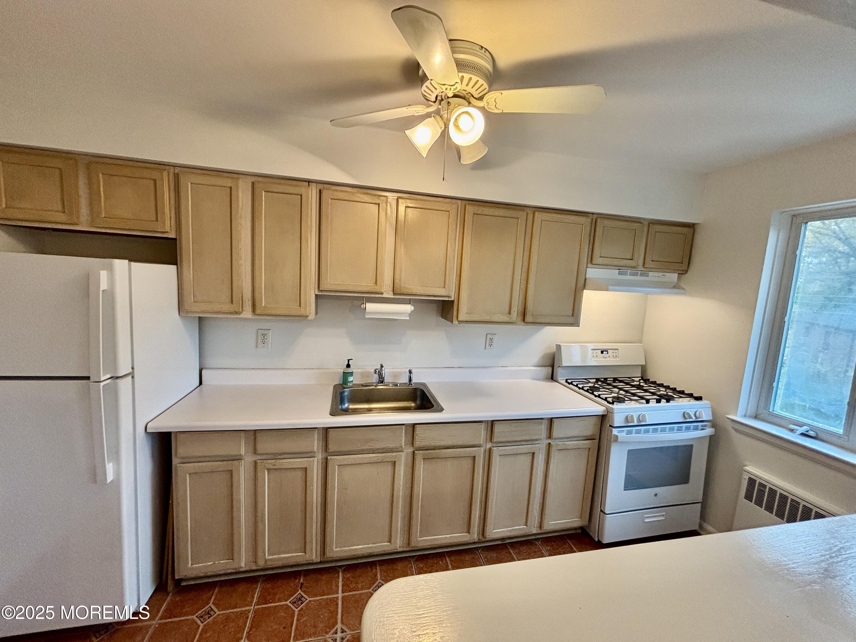 283 Spring Street, Unit 4C Red Bank, NJ 07701 - Photo 4 of 29 a kitchen with stainless steel appliances a stove a sink a refrigerator a counter space and cabinets