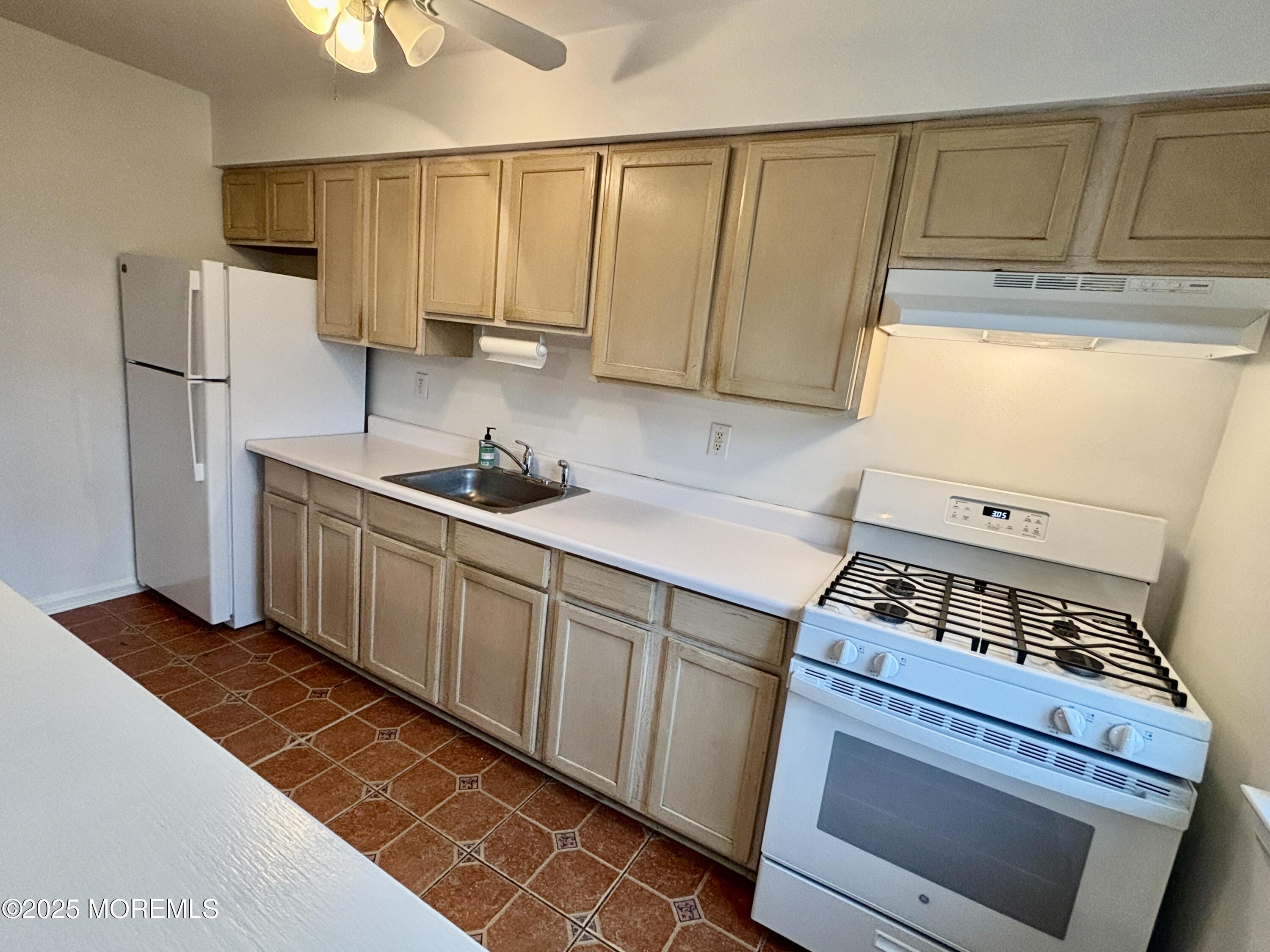 283 Spring Street, Unit 4C Red Bank, NJ 07701 - Photo 6 of 29 a kitchen with stainless steel appliances a stove a refrigerator and cabinets