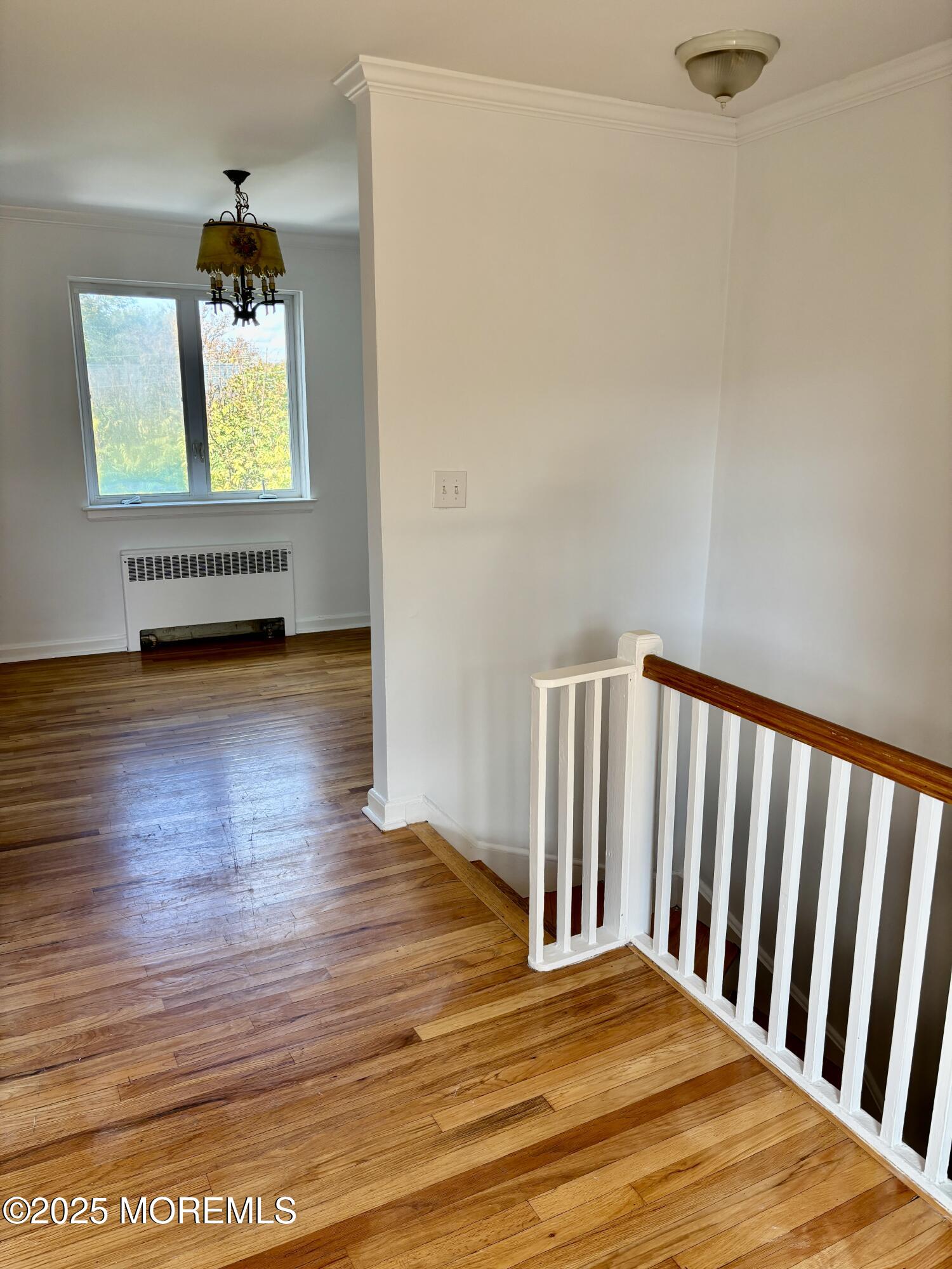 283 Spring Street, Unit 4C Red Bank, NJ 07701 - Photo 8 of 29 a view of an empty room with wooden floor and a window